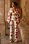 Woman wearing floral blazer, trouser and bralette set