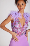 close up of a women wearing Alicia purple jumpsuit with plunging neckline and faux fur purple shoulders