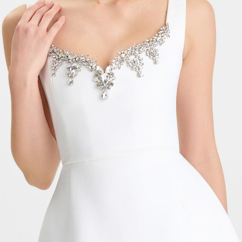 White dress with intricate silver embellishments on a white background
