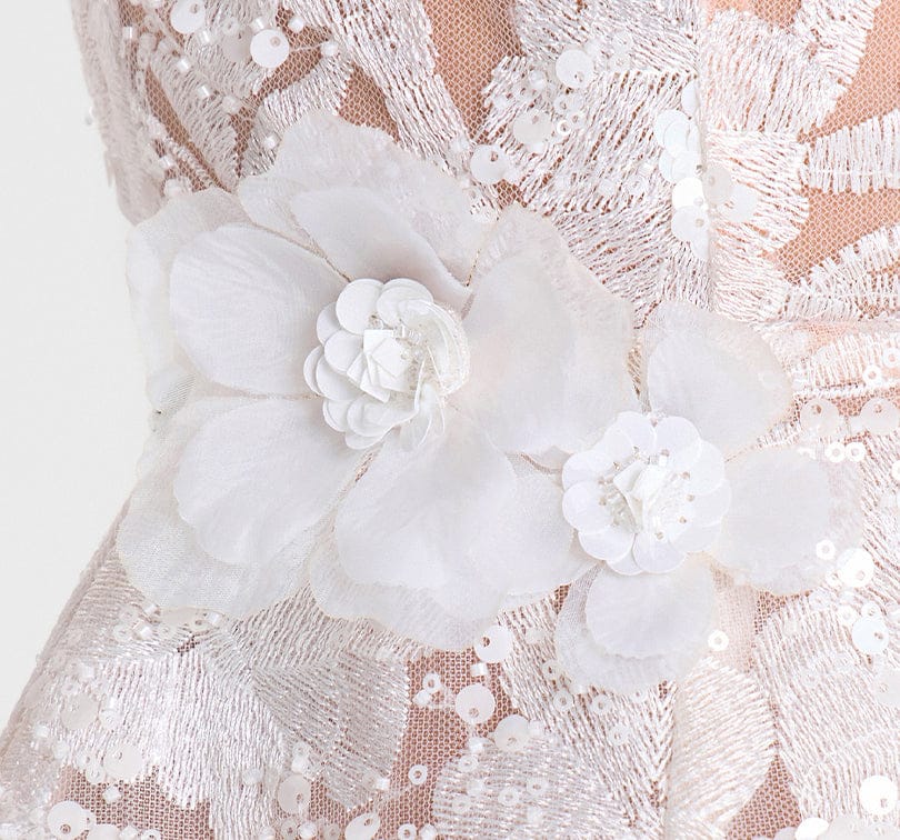 Close-up of a lace fabric with white floral embellishments