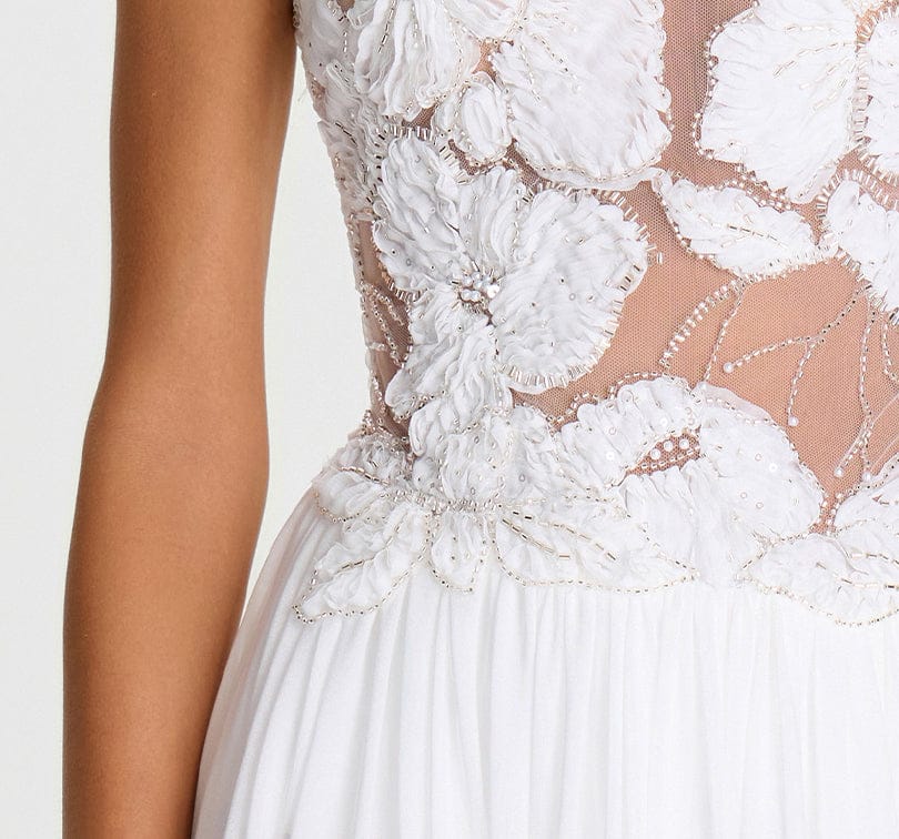 Close-up of a white floral embroidered dress on a plain background