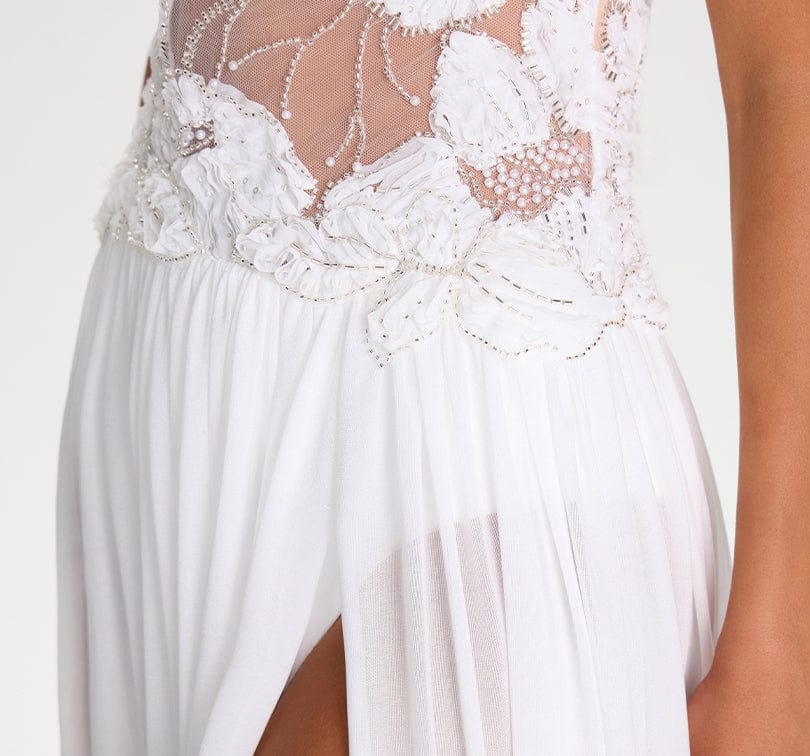 White dress with intricate lace detailing on a plain background