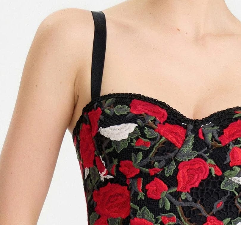 Black lace top with red floral embroidery on a white background