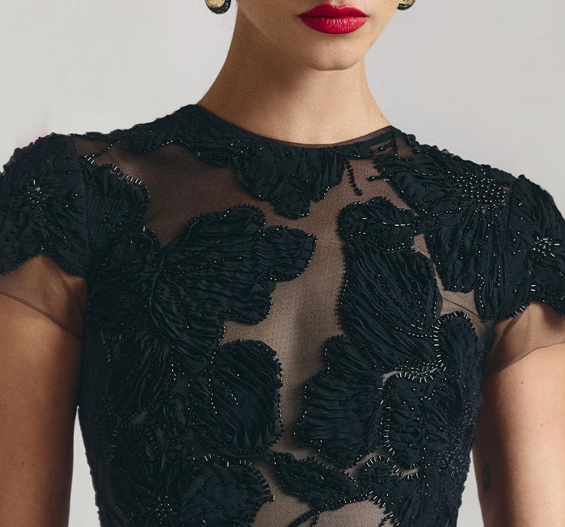 Black embroidered dress with a plain background