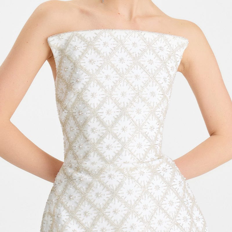 White strapless dress with textured pattern on a white background