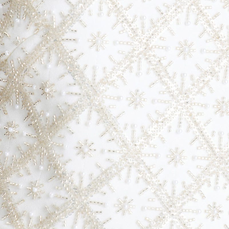 Close-up of a textured white surface with small decorative elements