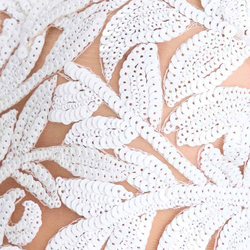 Close-up of white lace fabric on a beige background
