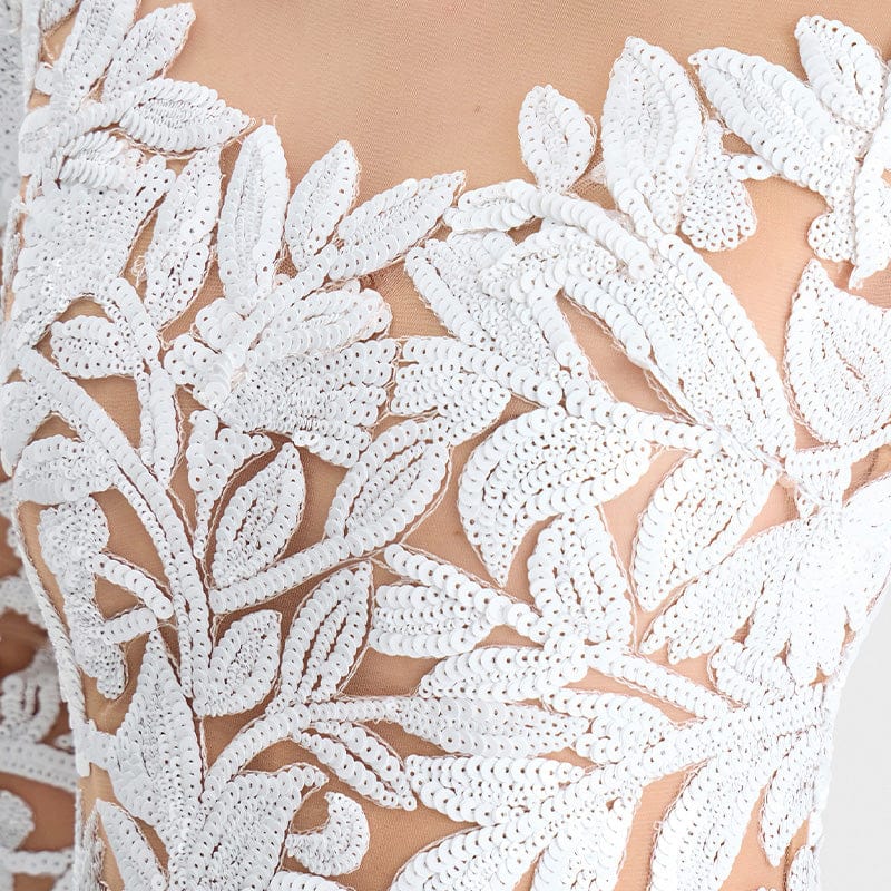 Close-up of white lace fabric with floral patterns on a beige background